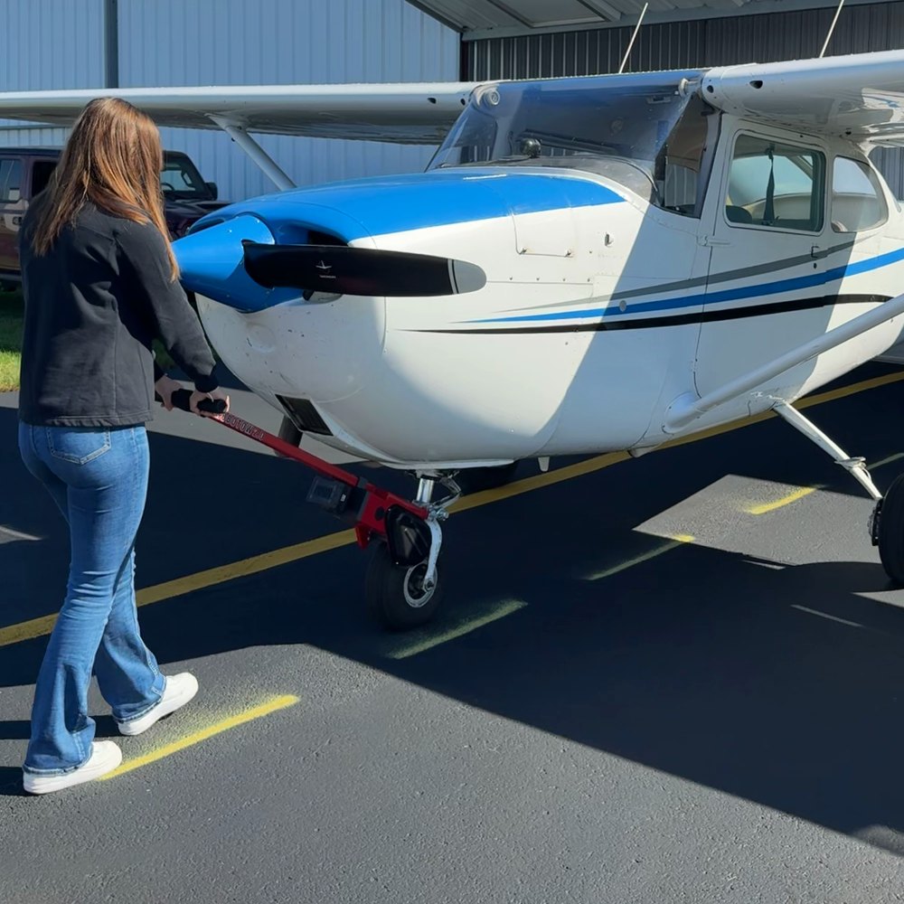 One person moving a Cessna 172 across the ramp with a Robotow 2.0.
