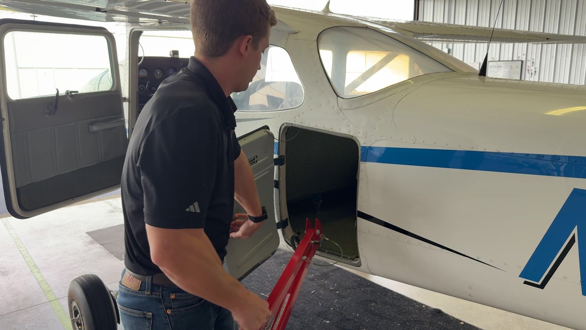 A Robotow 2.0 Pro, folded, going into an airplane baggage compartment.