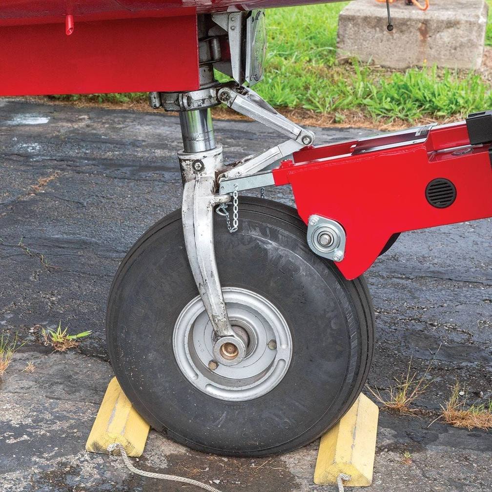 A Robotow 2.0 hooked to a Piper Aztec nose wheel, ready to move the airplane.