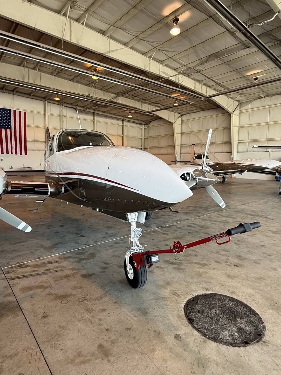 A Robotow on the nose gear of a Cessna 310R in the hangar.